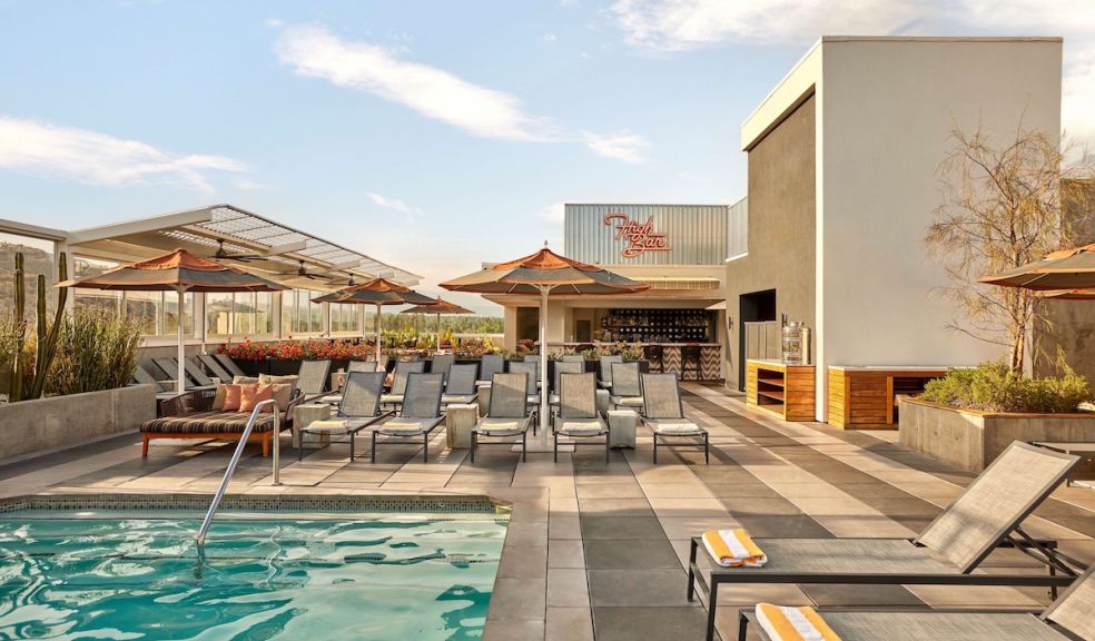 Kimpton Rowan hotel rooftop pool, cabanas and bar in Palm Springs, California