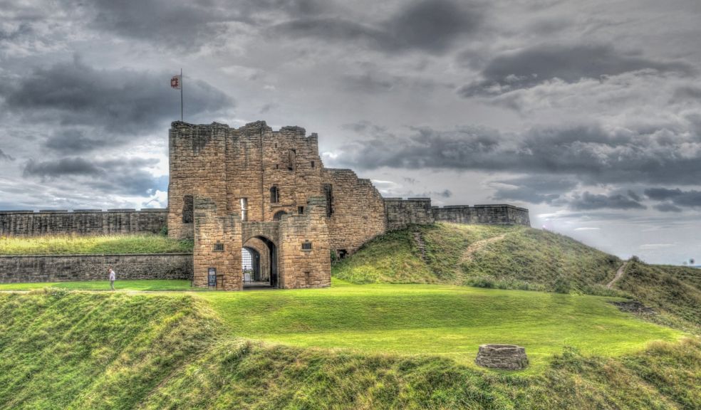 Newcastle castle on a hill surrounded by cloud