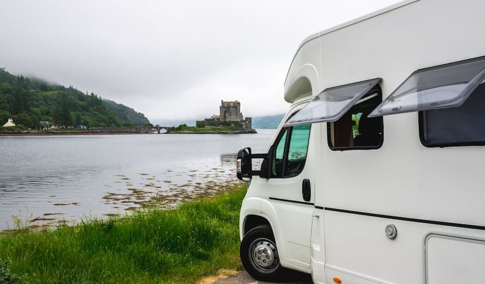 motor home parked next to a lake
