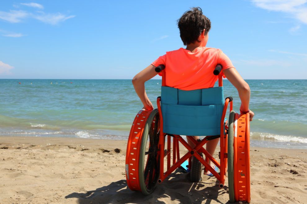 boy wheelchair beach accessible holiday accommodation travel