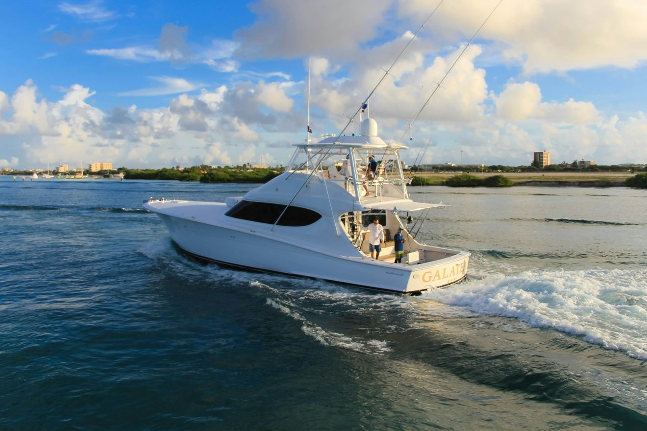 white and blue boat on the sea during daytime 