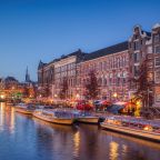 a canal in Amsterdam with lots of canal boats