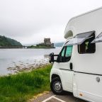 motor home parked next to a lake