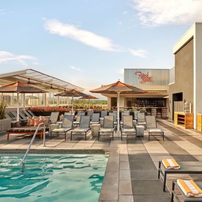 Kimpton Rowan hotel rooftop pool, cabanas and bar in Palm Springs, California