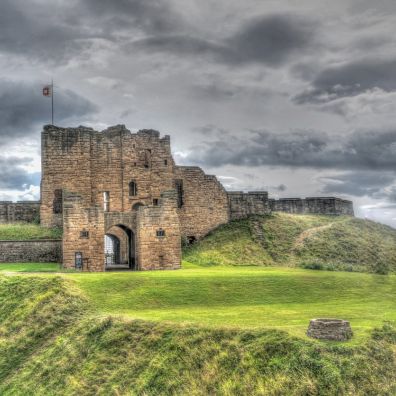 Newcastle castle on a hill surrounded by cloud